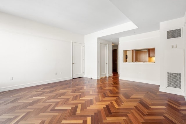 spare room featuring dark parquet floors