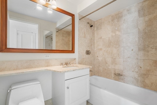 full bathroom with tiled shower / bath, toilet, and vanity