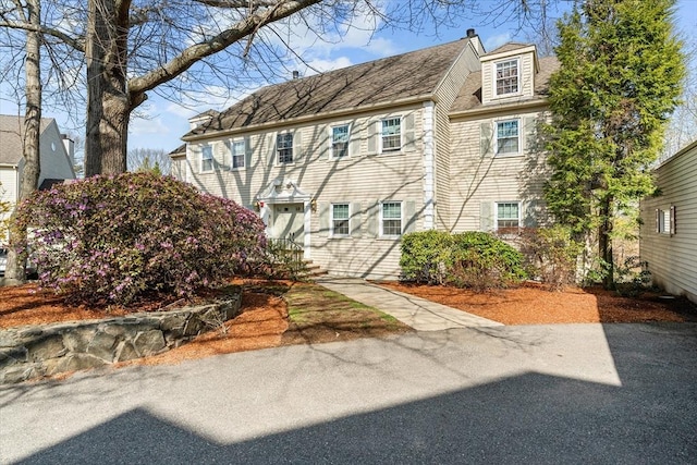 multi unit property featuring roof with shingles