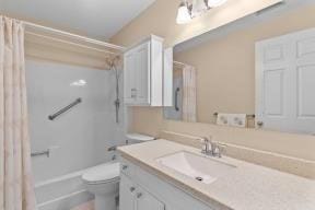 full bathroom with toilet, shower / tub combo, and vanity