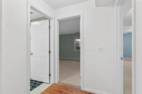 hall featuring baseboards and wood finished floors