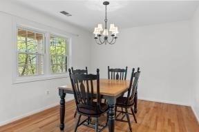 dining area featuring baseboards, visible vents, light wood-style flooring, and a notable chandelier