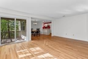 living room with an inviting chandelier and wood finished floors