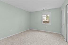 unfurnished bedroom with a closet, baseboards, and carpet flooring