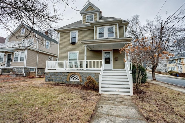 view of front of home featuring covered porch and a front yard