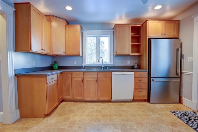 kitchen featuring sink, dishwasher, and stainless steel fridge