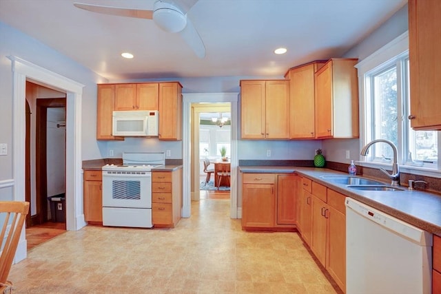 kitchen featuring sink, white appliances, light brown cabinetry, and ceiling fan