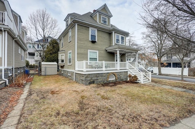 view of front of home with a porch and a front lawn