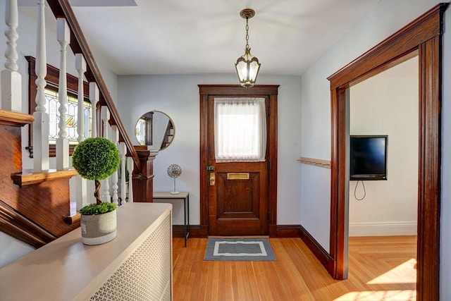 foyer entrance with light hardwood / wood-style floors