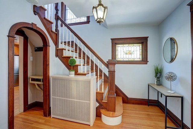 stairs featuring hardwood / wood-style floors