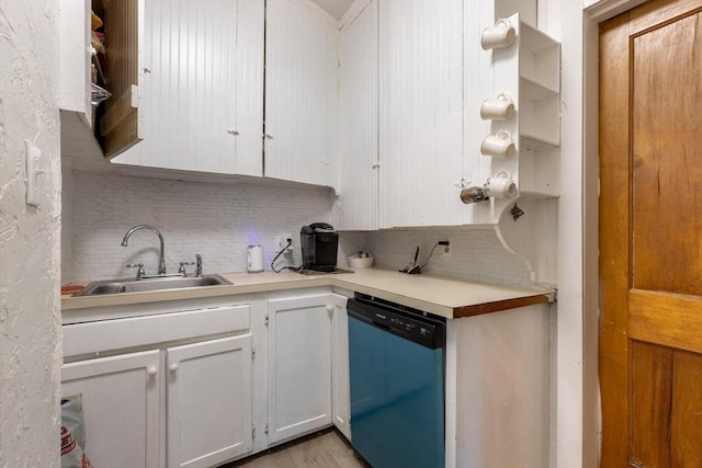 kitchen with sink, light hardwood / wood-style flooring, stainless steel dishwasher, decorative backsplash, and white cabinetry