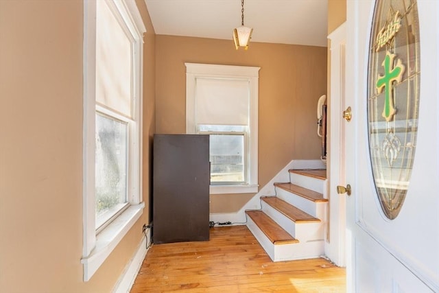 stairway with hardwood / wood-style flooring and plenty of natural light