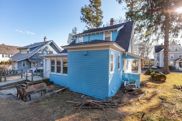 back of house featuring a sunroom