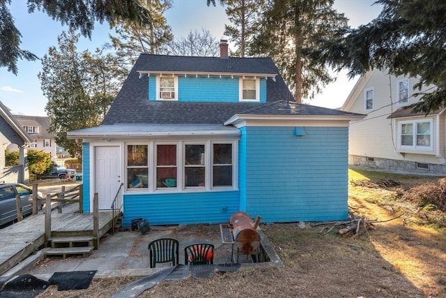 rear view of property with a patio area and a wooden deck