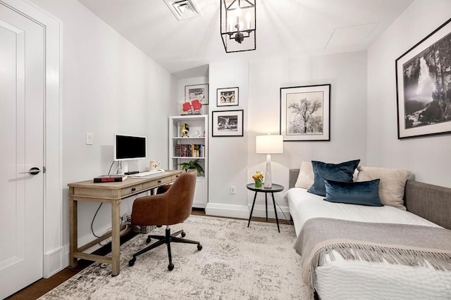 office featuring baseboards, wood finished floors, and visible vents