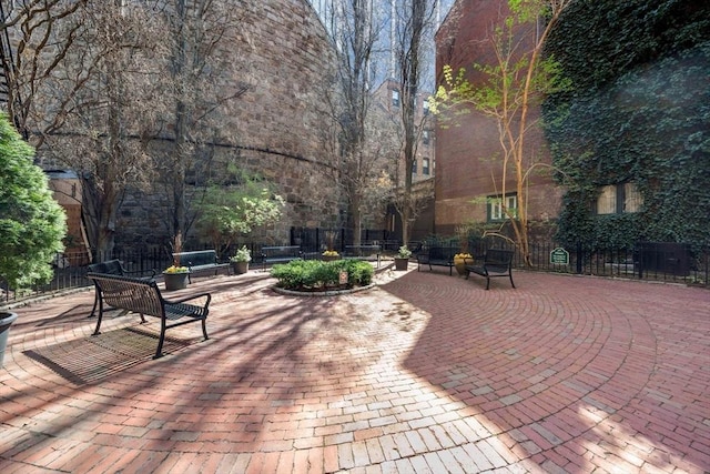 view of property's community featuring fence and a patio area