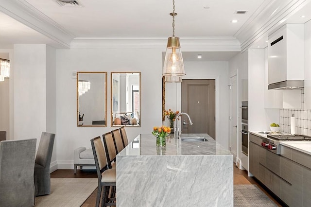dining space with crown molding, wood finished floors, and visible vents