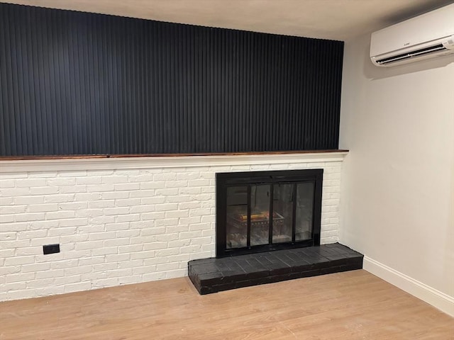 details featuring hardwood / wood-style flooring, a brick fireplace, and a wall mounted air conditioner