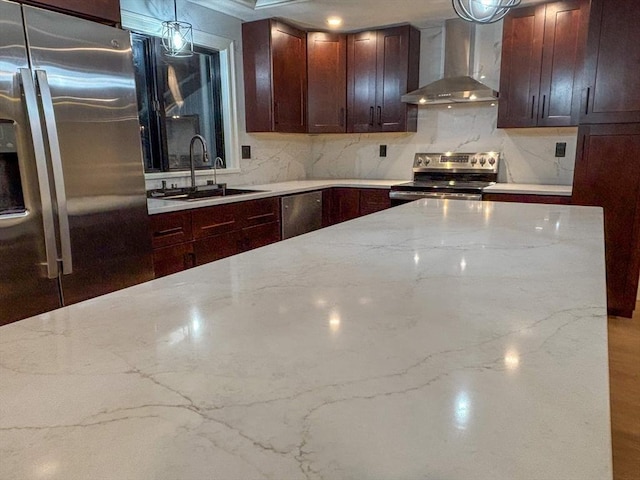 kitchen with wall chimney exhaust hood, sink, tasteful backsplash, light stone countertops, and stainless steel appliances