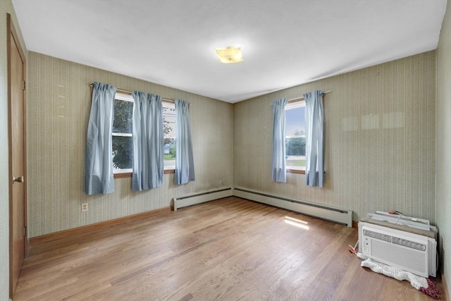 1032 Tinkham Rd, Wilbraham, MA 01095 - spare room featuring wood finished floors, wallpapered walls, plenty of natural light, a baseboard heating unit, and baseboards