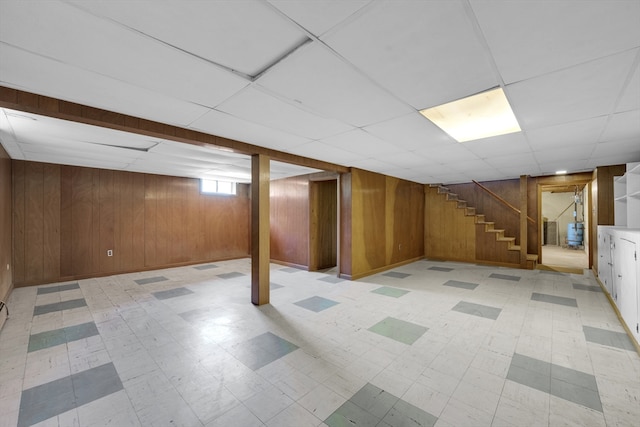 1032 Tinkham Rd, Wilbraham, MA 01095 - below grade area with stairway, wood walls, light flooring, and a paneled ceiling
