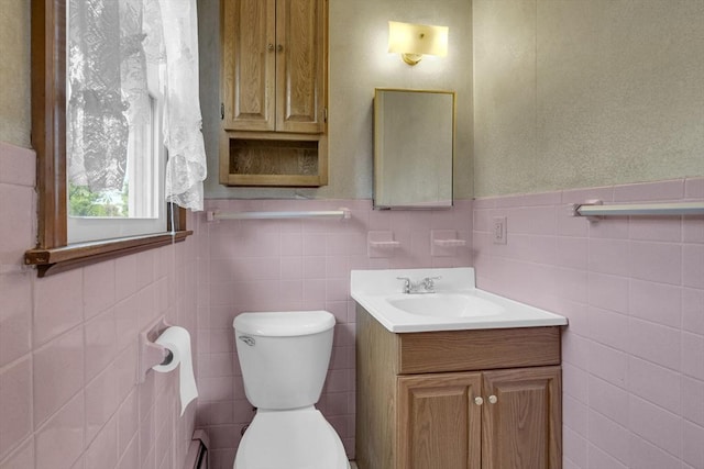 1032 Tinkham Rd, Wilbraham, MA 01095 - half bathroom featuring tile walls, vanity, toilet, and a wainscoted wall