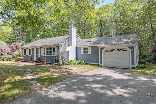 24 Powderhorn Way, Sandwich, MA 02563 - single story home featuring an attached garage, a chimney, asphalt driveway, and roof with shingles