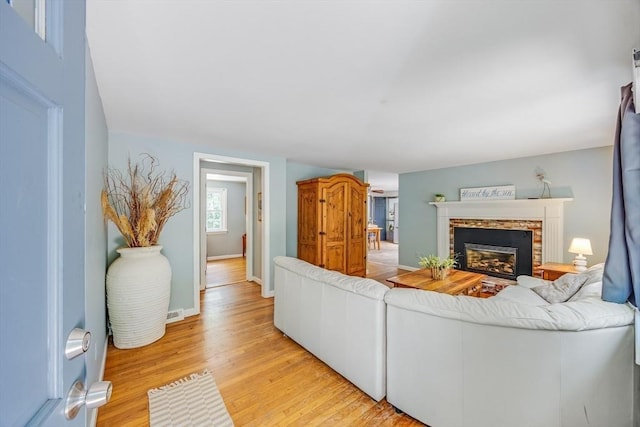 24 Powderhorn Way, Sandwich, MA 02563 - living area with a fireplace and light wood-style floors