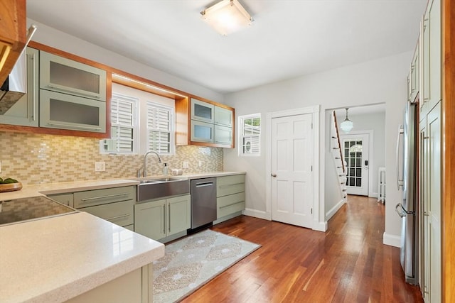 17 Perry St, Somerville, MA 02143 - kitchen featuring dishwasher, a sink, backsplash, dark wood-style floors, and light countertops
