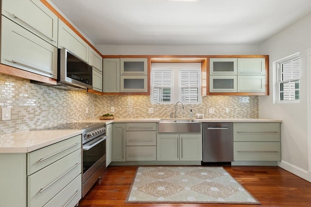 17 Perry St, Somerville, MA 02143 - kitchen with stainless steel appliances, a sink, dark wood-style floors, and decorative backsplash