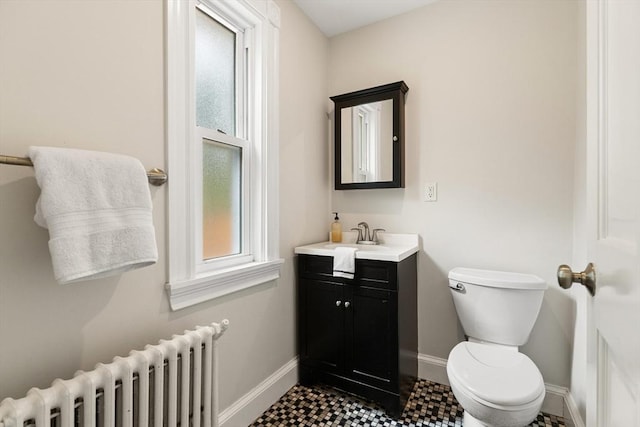 17 Perry St, Somerville, MA 02143 - half bathroom with radiator heating unit, baseboards, toilet, and vanity