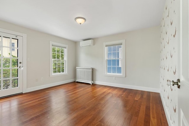 17 Perry St, Somerville, MA 02143 - spare room with radiator heating unit, a wall mounted air conditioner, hardwood / wood-style floors, and baseboards
