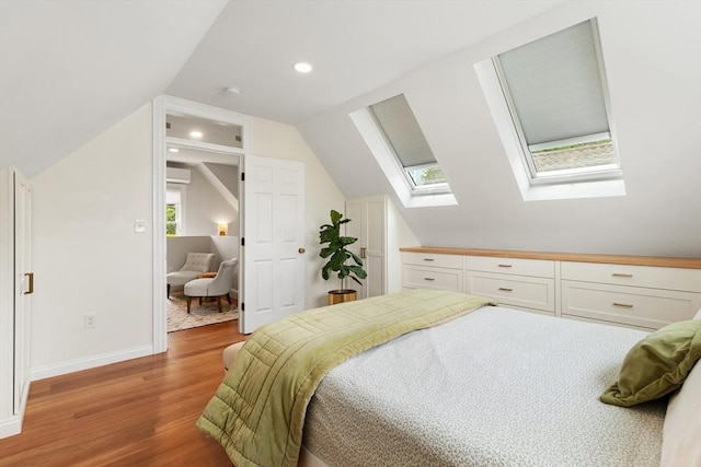 17 Perry St, Somerville, MA 02143 - bedroom with a skylight, wood finished floors, vaulted ceiling, baseboards, and recessed lighting