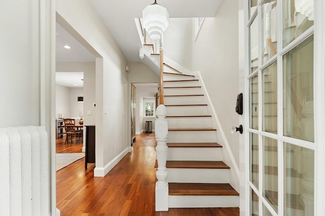 17 Perry St, Somerville, MA 02143 - staircase featuring wood finished floors, baseboards, and recessed lighting