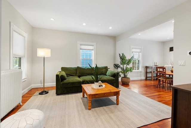 17 Perry St, Somerville, MA 02143 - living room with plenty of natural light, radiator heating unit, wood finished floors, baseboards, and recessed lighting