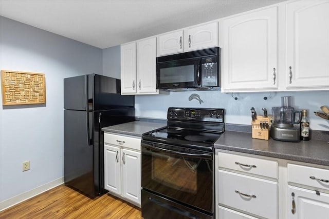 kitchen with light hardwood / wood-style flooring, white cabinets, and black appliances