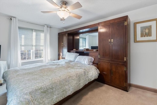 bedroom featuring ceiling fan and light carpet