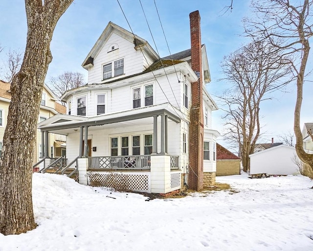 view of front of home with a porch and a chimney