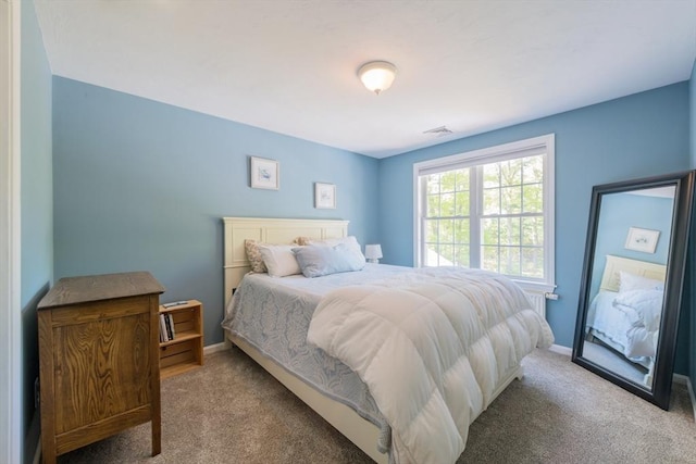 bedroom with carpet flooring and baseboards
