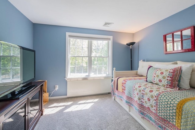 carpeted bedroom with radiator heating unit