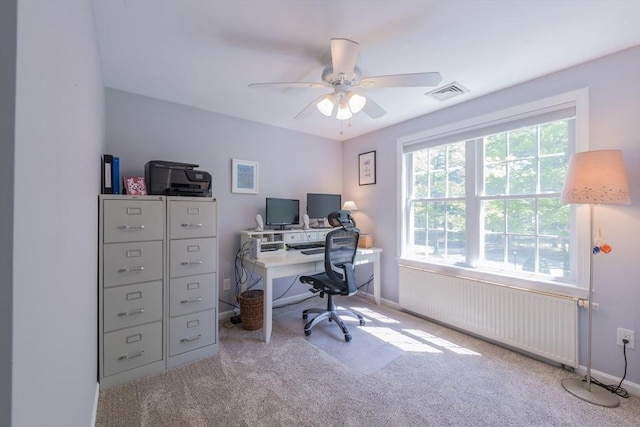 office space featuring radiator, carpet flooring, ceiling fan, and baseboards