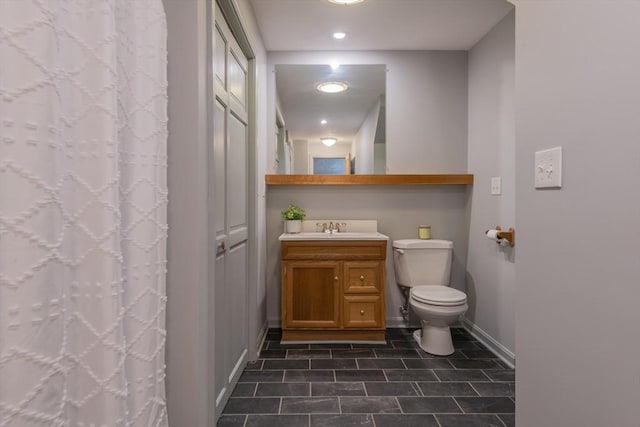 bathroom featuring toilet, baseboards, vanity, tile patterned floors, and a shower with shower curtain