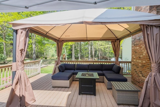 deck with a gazebo and an outdoor living space with a fire pit