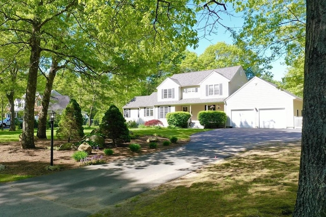 traditional-style home with asphalt driveway and an attached garage