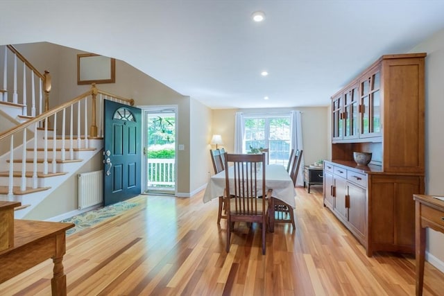 dining space with light wood finished floors, stairway, radiator heating unit, recessed lighting, and baseboards