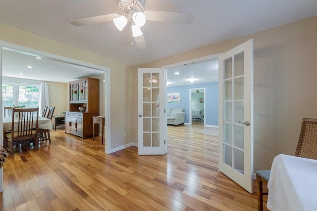 dining area with french doors, light wood finished floors, ceiling fan, baseboards, and recessed lighting