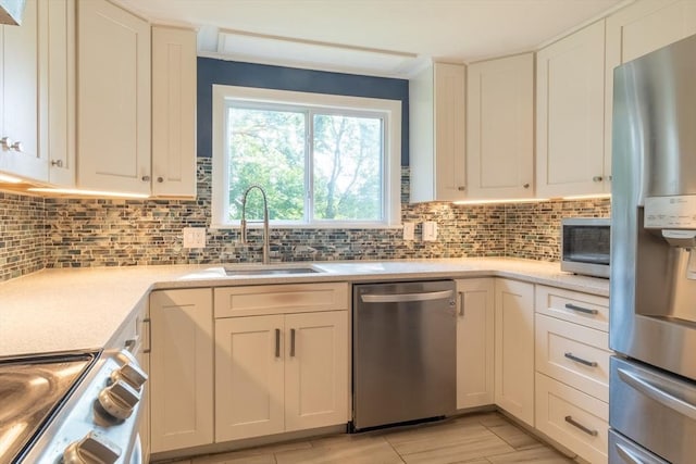 31 Melwood Ave, East Longmeadow, MA 01028 - kitchen with stainless steel appliances, backsplash, and white cabinetry