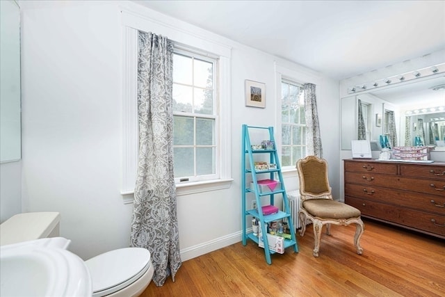 bathroom featuring hardwood / wood-style flooring and toilet