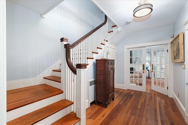 staircase with wood-type flooring and french doors