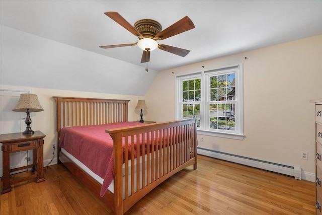 bedroom featuring light wood-type flooring, ceiling fan, lofted ceiling, and baseboard heating